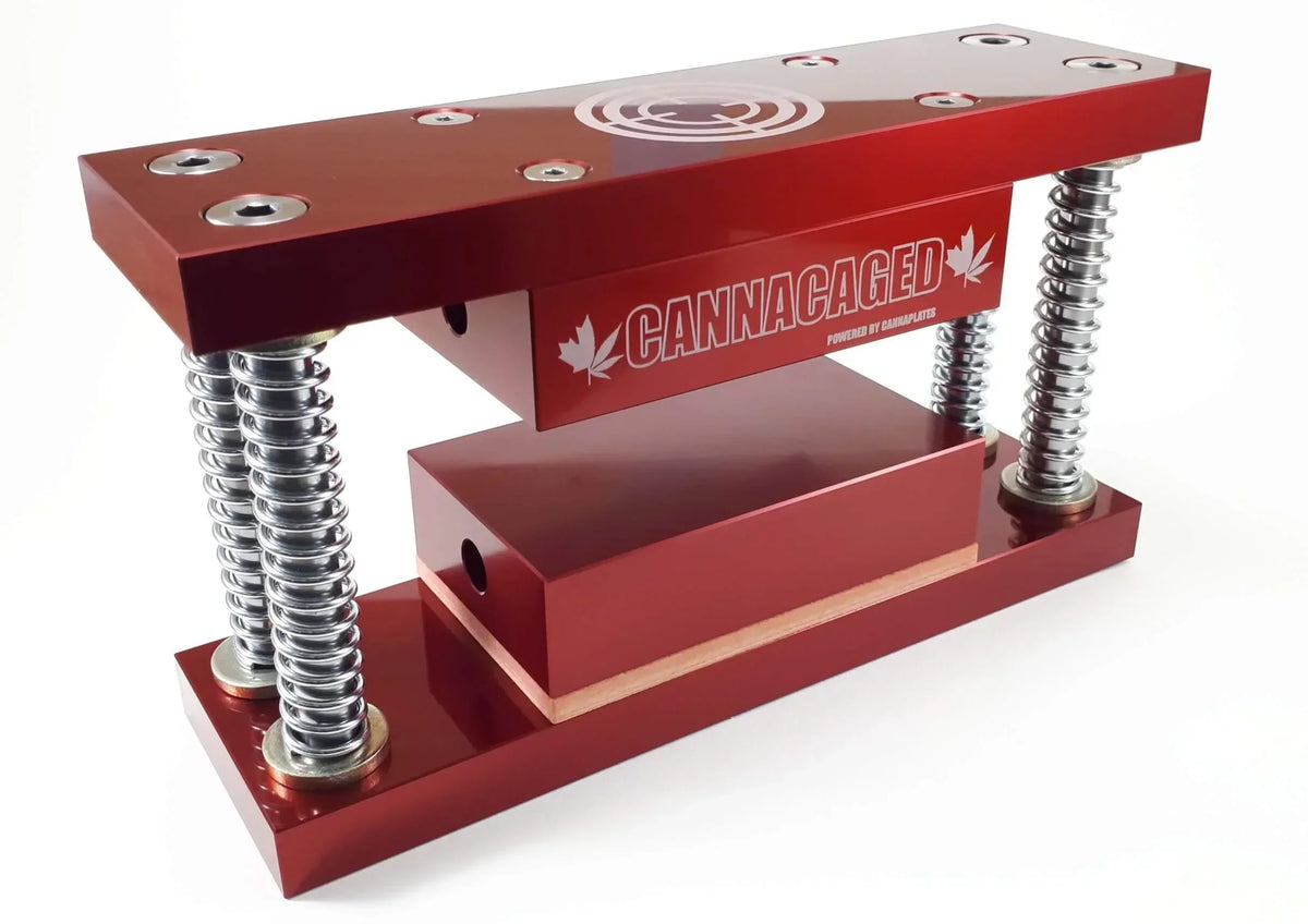 Red CannaCaged rosin press plates with heavy-duty springs and heated platens.