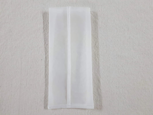 White mesh rosin press bag for botanical extraction on a neutral background.
