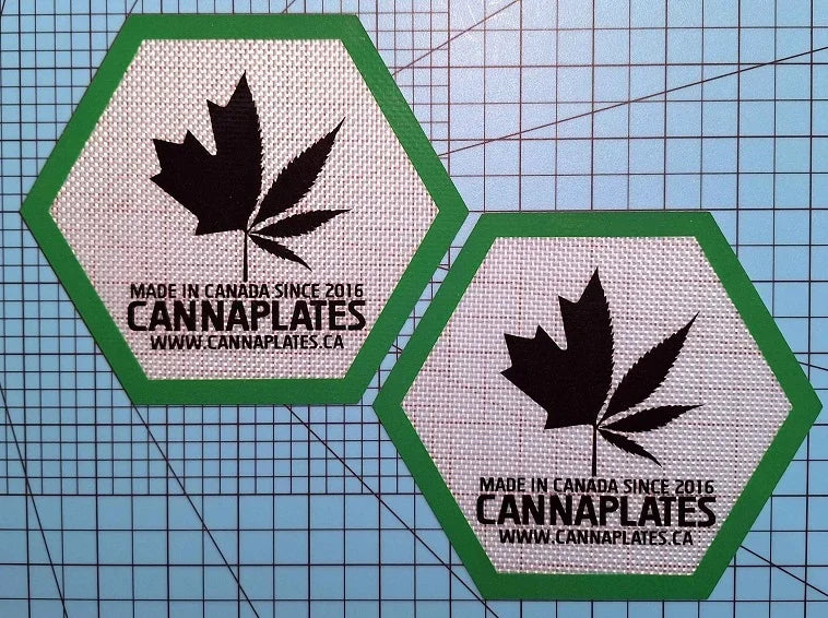 Two hexagonal CannaPlates brand patches featuring a cannabis leaf logo and website URL.