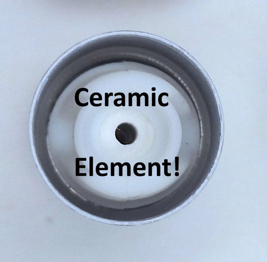Close-up view of a white ceramic heating element inside a metal component.