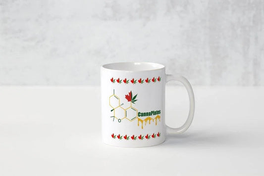 White ceramic mug featuring a cannabis molecule design and CannaPlates logo.