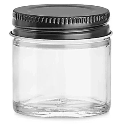 Small clear glass jar with a black metal screw-on lid.
