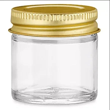 Small clear glass jar with a gold metal screw-on lid