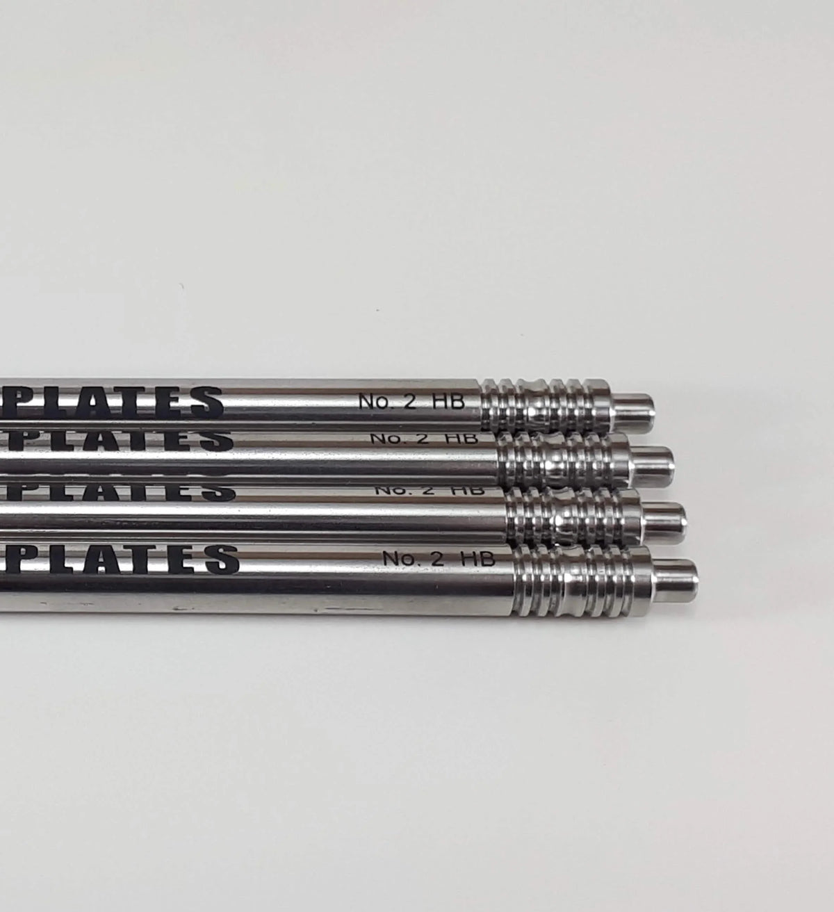 Four stainless steel No. 2 HB precision metal rods on a white background.