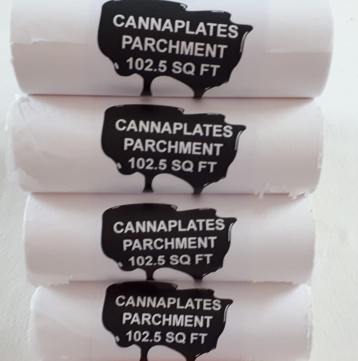 Four rolls of CannaPlates parchment paper, each labeled as 102.5 SQ FT.