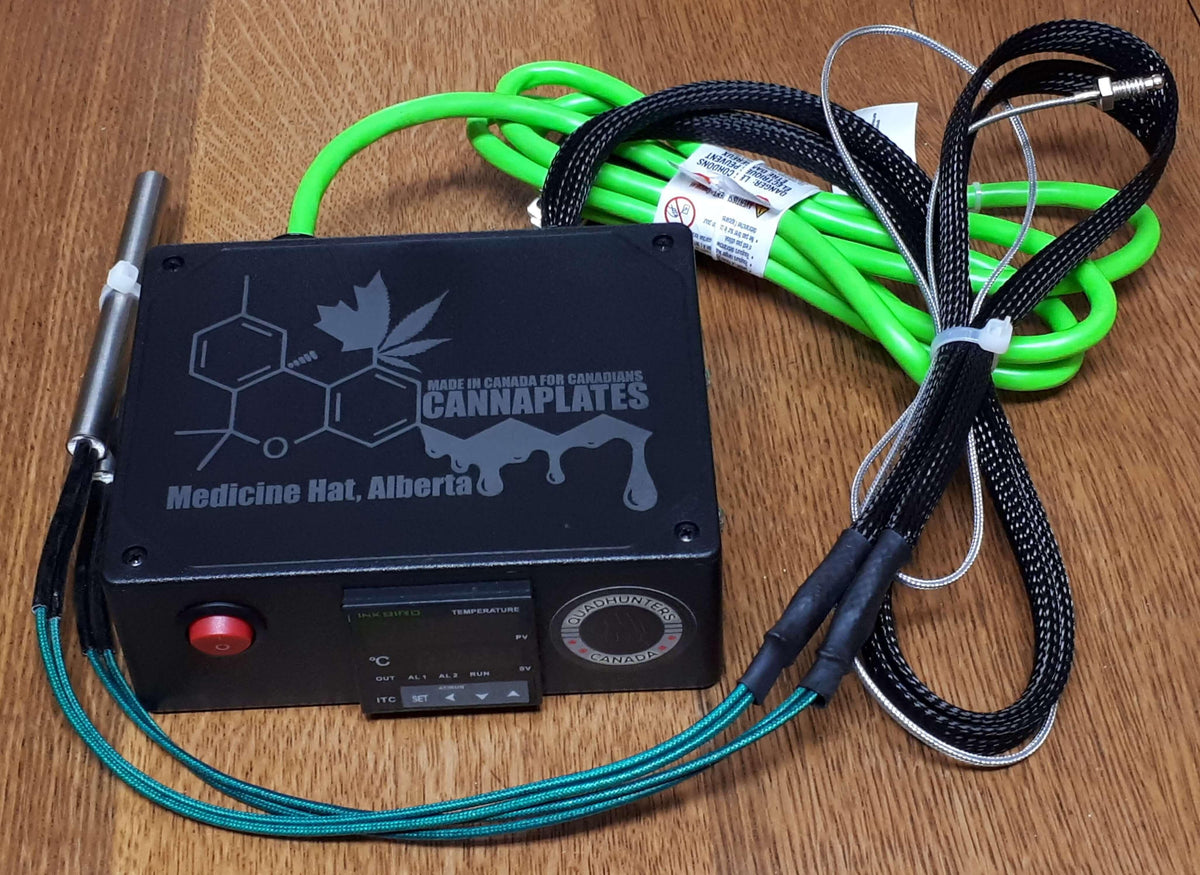 CannaPlates digital temperature controller with green and black heating cables on wood.